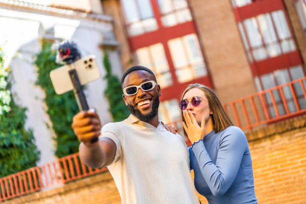 istock Multi-ethnic couple using mobile phone for vlogging outdoors 2181134008