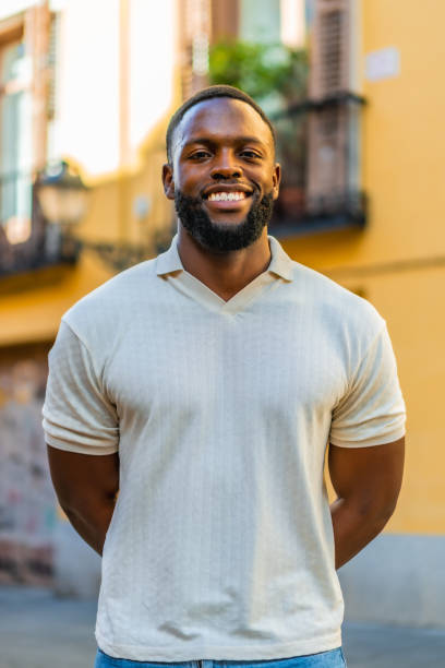 istock Smiling african man looking at camera in the street 2181134033