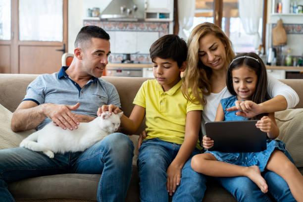 istock A family relaxing at home with a cat and a digital tablet 2181134903