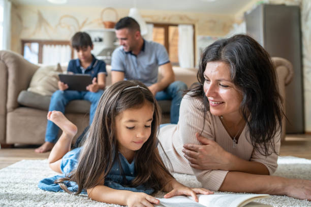 istock A mom and daughter reading at home 2181134926