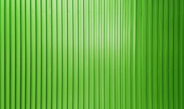 istock real chrome light green corrugated metal sheet wall showing vertical pattern, bolts, screw. modern industrial green metal sheet wall facade. 2181137167