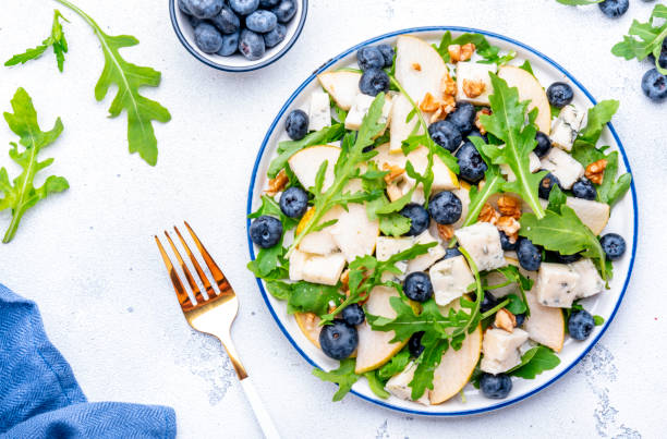 istock Salad with pear, blueberries, blue cheese, arugula and walnuts. White background, top view 2181138263