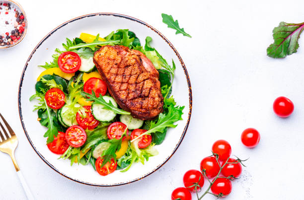 istock Salad with duck breast, lettuce and vegetables, white background, top view 2181138268