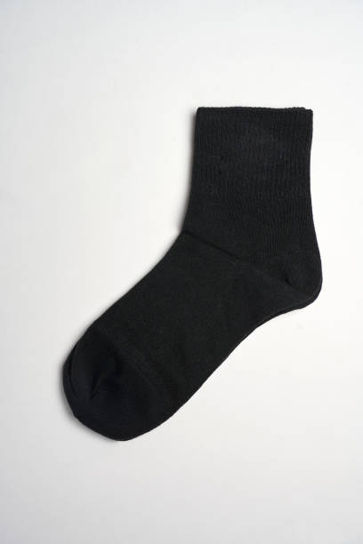 istock Black socks on a white background with copy space, close-up. New cotton socks advertisement 2181140478
