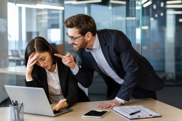istock Stressed businesswoman facing angry boss during tense office confrontation at work desk 2181141052