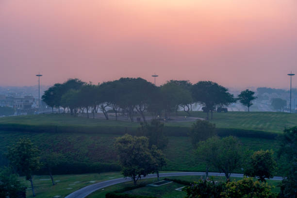Doha, Qatar, September 27, 2024: A peaceful view of Katara Hills at dusk, highlighting the rolling landscape and lush greenery. The golden light creates a tranquil atmosphere for visitors.
