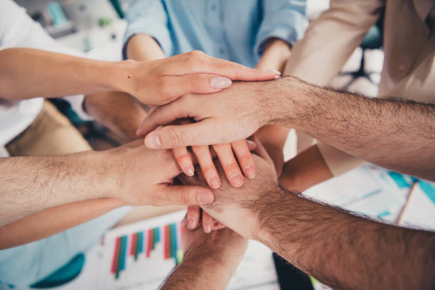 istock Cropped portrait of group professional corporate workers pile stack handshake loft interior business center indoors 2181141863
