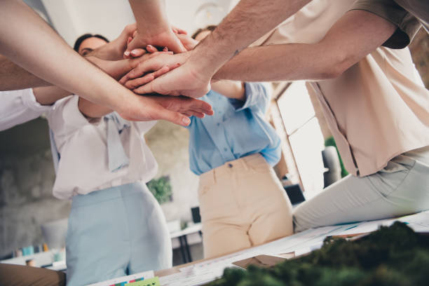 istock Croppe photo of group business company workers pile stack hands agreement modern loft interior office indoors 2181141865