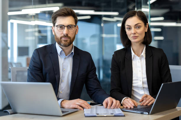 istock Professional business team in modern office setting with technology and paperwork demonstrating confidence and teamwork 2181142927