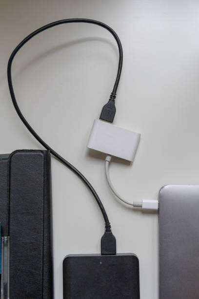 istock USB to USB-C external hard drive laptop data transfer adapter on office desk close up 2181144890