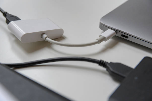 istock USB to USB-C external hard drive laptop data transfer adapter on office desk close up 2181144933