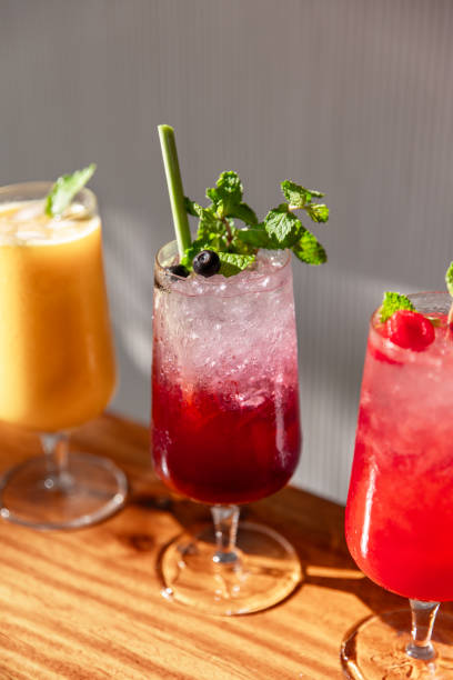 istock Colourful juice drinks with fruit cocktail Mocktail cooler Lemonade glasses served with crushed ice, mint and lime in sunny restaurant cafe bar 2181145022