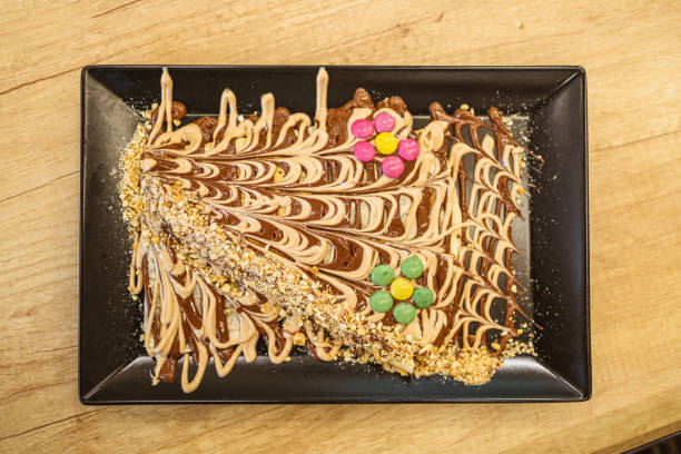 Crepes with Chocolate and Colorful Toppings on Plate