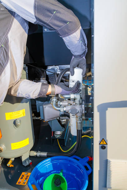 istock Industrial maintenance technician changing filter of a large air compressor 2181148846
