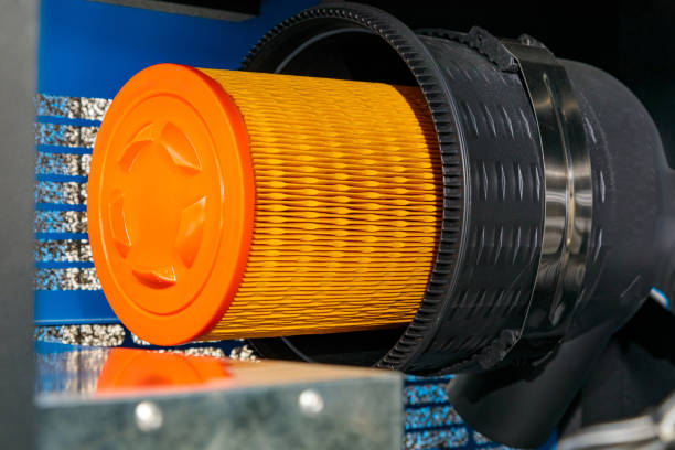 Close-up of a new cylindrical air filter being installed in industrial machinery, ensuring clean and efficient operation