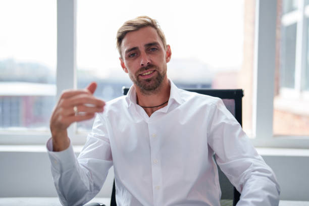 istock Man with sunglasses looking at the camera in office with computer. Businessman is working on business ideas in light office in business center. Concept people in a office job. 2181149737