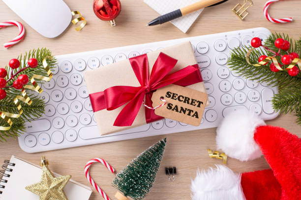 istock A cheerful office desk setup with Christmas decorations including a wrapped gift, keyboard, mini tree, and candy canes, capturing the spirit of Secret Santa in the workplace 2181152631