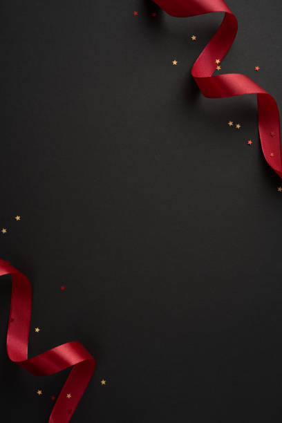 A striking black vertical background is adorned with elegantly flowing burgundy ribbons, perfect for Black Friday sales promotions or festive gift themes