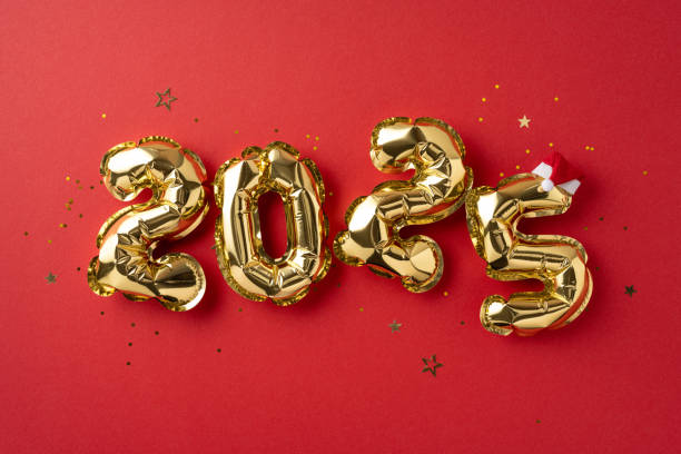 istock Festive 2025 celebration featuring shiny golden number balloons on a vibrant red backdrop. Ideal for New Year party themes and holiday decorations 2181152668