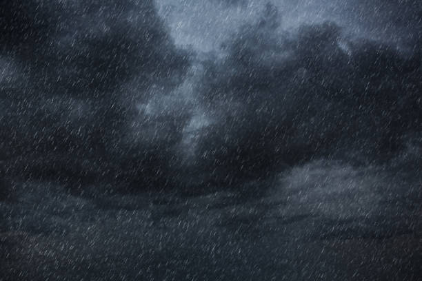 Dark clouds fill the sky, heavy with rain and creating a gloomy, wet atmosphere. The dense formations of clouds convey a sense of impending storm, enhancing the mood of isolation and foreboding