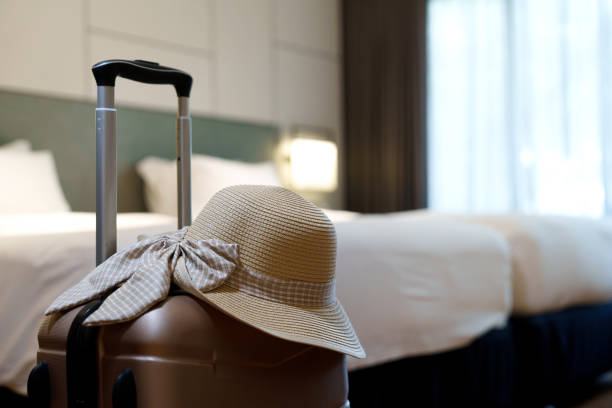 istock Travel Suitcase with Sun Hat in a Hotel Room 2181163096