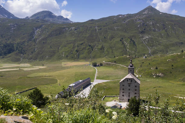 Brig, Switzerland, 18 July 2024: View of the old granite hospice (Alter Spittel) and landscape on the Simplon Pass in Switzerland. Built in 1650, it is a landmark on the Stockalperweg hiking trail.