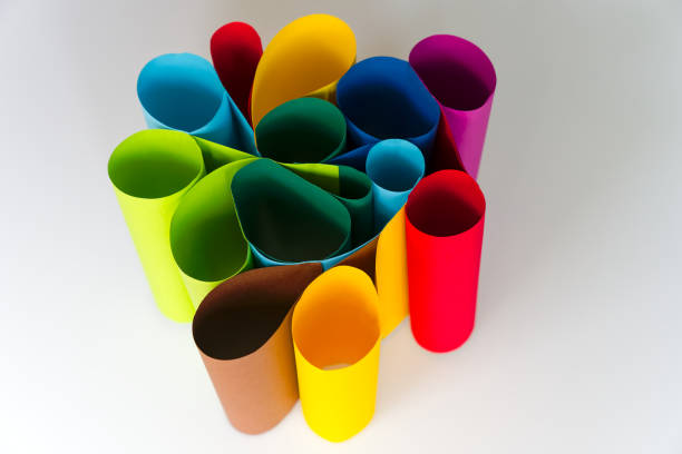 High angle view of paper sheets in different colors bend against white background. Photo made October 26th, 2024, Zurich, Switzerland.