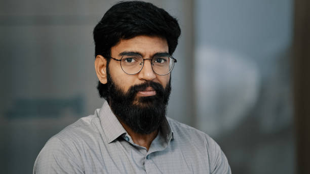 istock Arab hispanic handsome bearded man confident brunet guy in eyeglasses turn head at camera with positive facial expression indian young intelligent businessman leader worker male founder stand indoors 2181187791