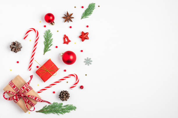 istock Christmas background with fir branches, gift boxes, red decorations, candy and pine cones isolated on white background. Flat lay. Happy New Year and winter holidays background. Top view 2181188802