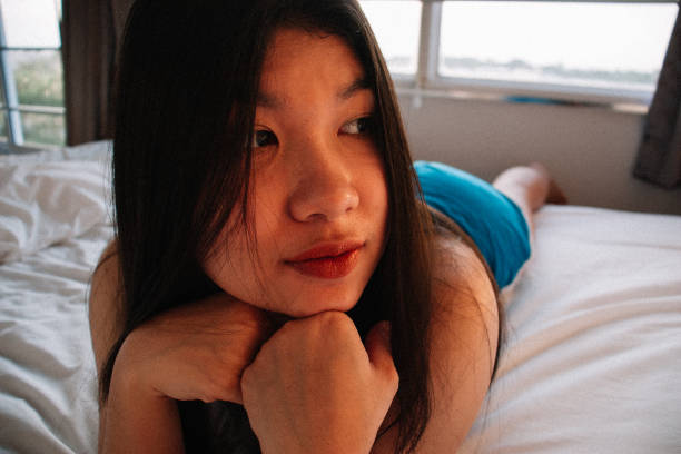 istock asian woman in bed 2181193700
