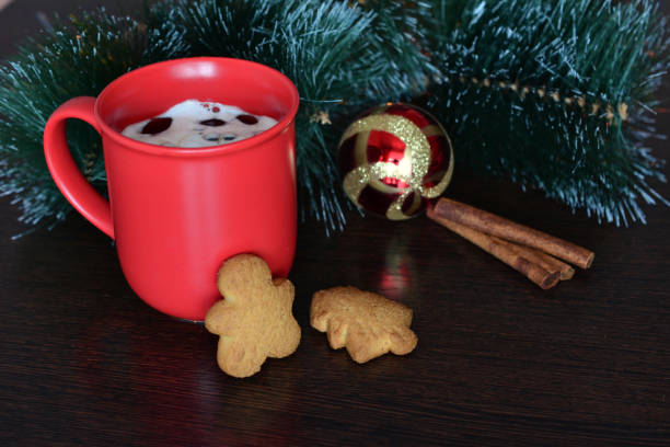 a christmas tree with a red cup of coffee and cookies