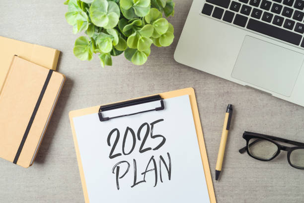 istock New Year 2025 plan and resolution business concept with notepad, laptop computer and plant on modern office desk. Top view, flat lay 2181194247