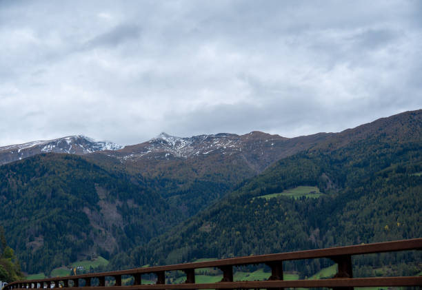 Alpine landscape with a guardrail in the foreground