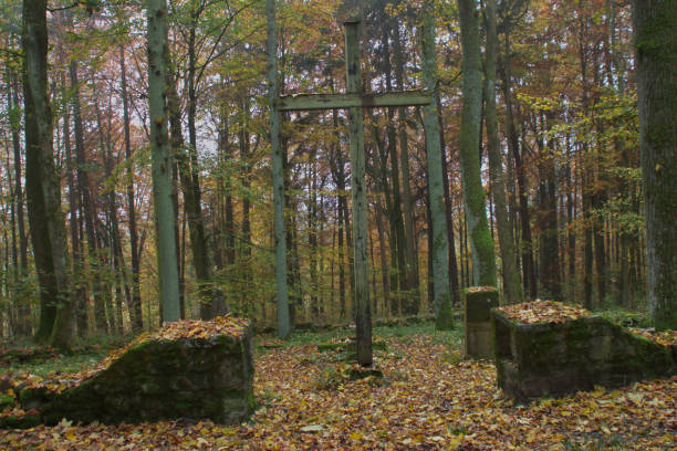 istock Ancient medieval graveyard with holy cross in autumn forest Halloween 2181198776