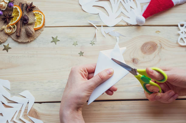 istock A snowflake made from paper with your own hands gracefully decorates a winter interior, adding warmth and a cozy atmosphere 2181199527