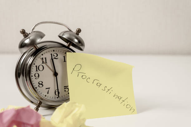 istock Procrastination: Close-up of an alarm clock and sticky notes, symbolizing procrastination 2181199638