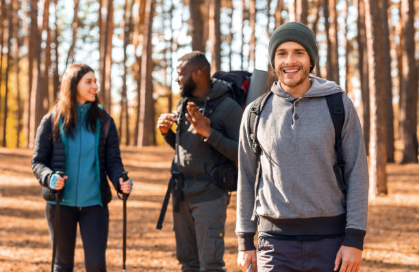istock Happy guy backpacker smiling over his talking friends 2181203645