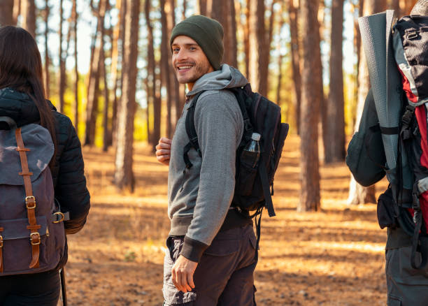 istock Handsome cheerful guy looking at camera, hiking with friends 2181203712