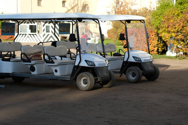 istock Two white golf carts against the backdrop of autumn bushes 2181210745
