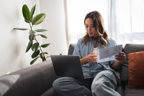 istock Young woman managing finances and working from home 2181212236