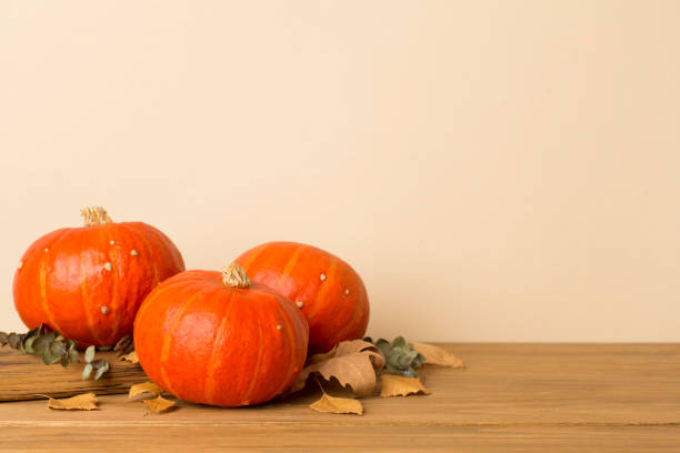 istock Orange pumpkins with autumn decor on wooden table 2181212313