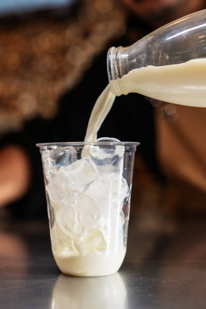 istock Pouring milk into iced disposable cup. 2181218109