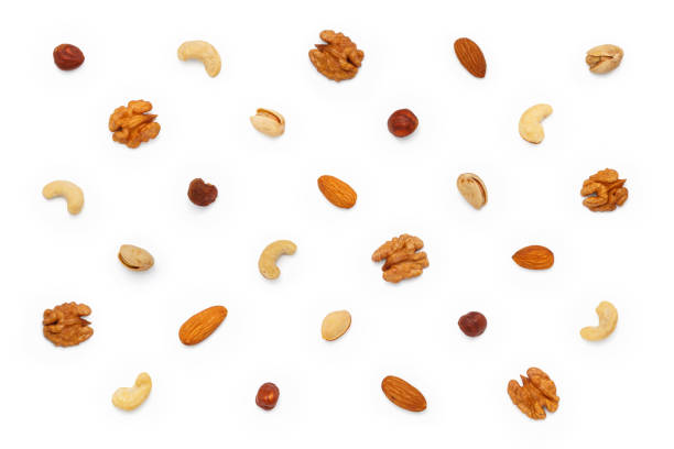 istock Background from different types of nuts and seeds. Isolated on white background 2181218572