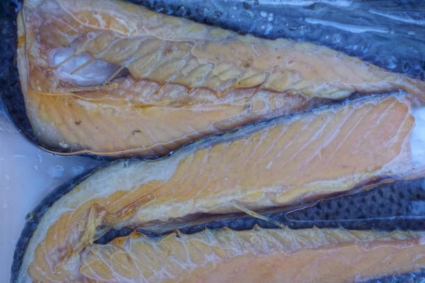 food from red pieces of fish salmon in cellophane transparent packaging