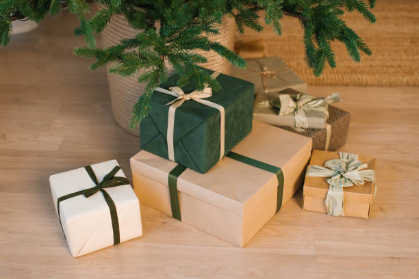 istock Stack of christmas presents are on a wooden floor 2181220600