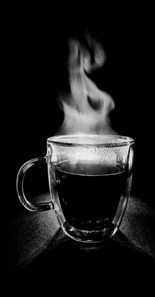 Hot coffee dances in gentle steam, smoke rising like a dream in flight.