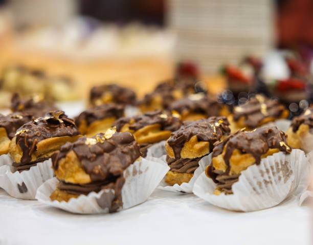 istock chocolate eclairs with glaze and nuts. Soft, decadent, patisserie 2181223083