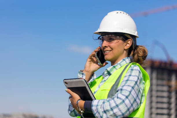 istock Young Female Engineer talking on phone  at construction site 2181225268