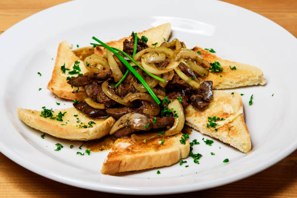 istock Fried liver with onions and toast on a white plate. Restaurant 2181229607