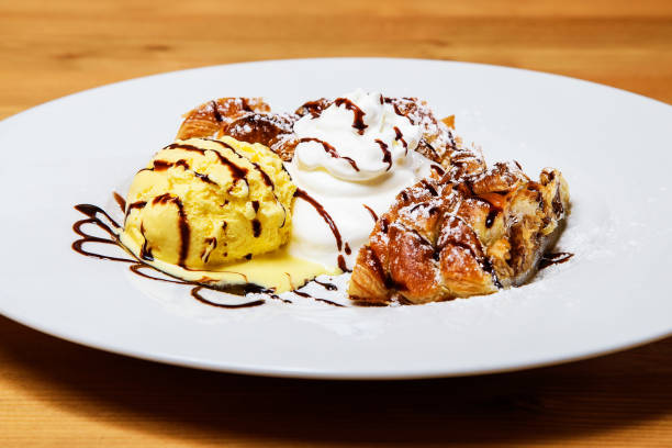 istock Apple strudel with ice cream and chocolate sauce on white plate 2181229924